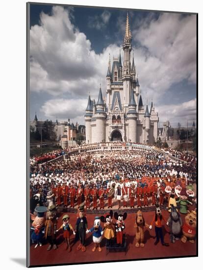 Walt Disney Characters and Park Staff Posing En Masse in Front of Cinderella's Castle-Yale Joel-Mounted Photographic Print
