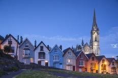 Ireland, County Cork, Cobh, Deck of Cards hillside houses and St. Colman's Cathedral, dusk-Walter Bibikw-Photographic Print