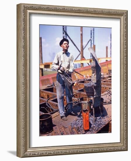 War Worker Holding Red Hot Metal Piece with Tongs at Shipyard-George Strock-Framed Photographic Print