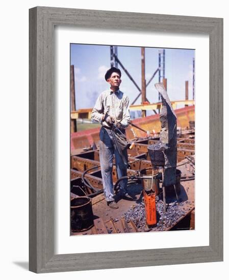 War Worker Holding Red Hot Metal Piece with Tongs at Shipyard-George Strock-Framed Photographic Print