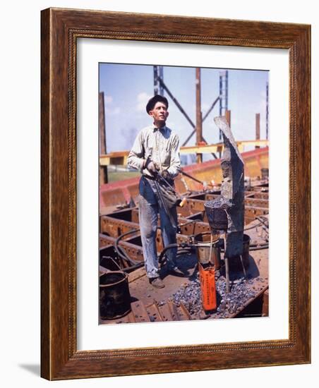 War Worker Holding Red Hot Metal Piece with Tongs at Shipyard-George Strock-Framed Photographic Print