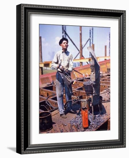 War Worker Holding Red Hot Metal Piece with Tongs at Shipyard-George Strock-Framed Photographic Print