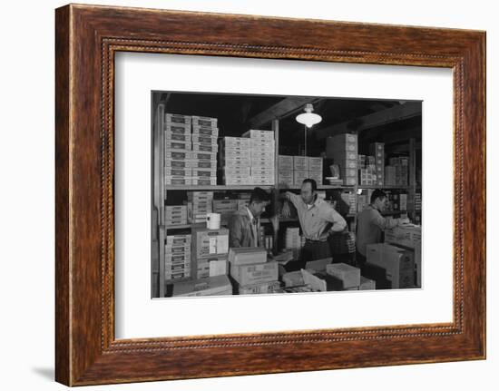 Warehouse manager M. Ogi with S. Sugimoto, manager of Co-op at Manzanar, 1943-Ansel Adams-Framed Photographic Print