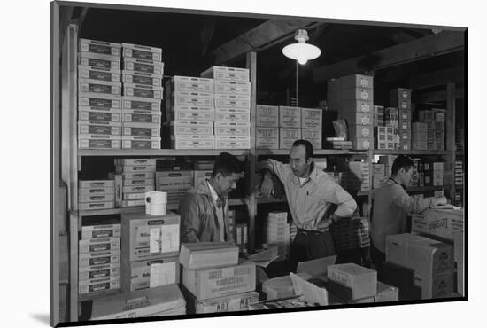 Warehouse manager M. Ogi with S. Sugimoto, manager of Co-op at Manzanar, 1943-Ansel Adams-Mounted Photographic Print