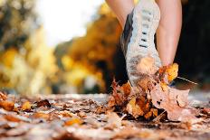 Close up of Feet of a Runner Running in Autumn Leaves Training for Marathon and Fitness Healthy Lif-warrengoldswain-Photographic Print