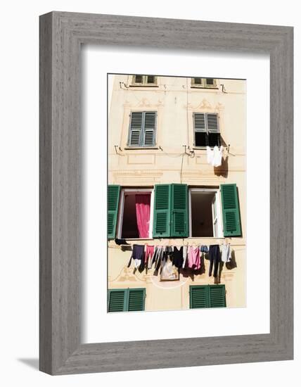 Washing hanging out of a window-Julian Castle-Framed Photo