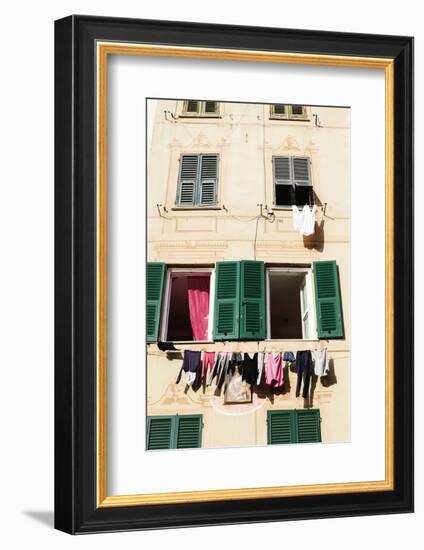 Washing hanging out of a window-Julian Castle-Framed Photo