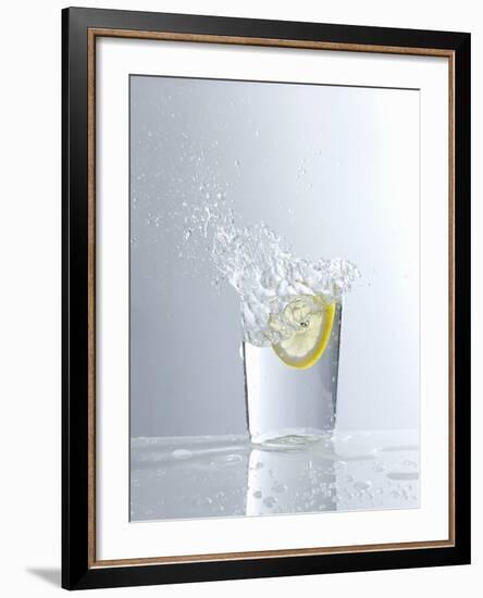 Water Splashing Out of a Glass-Karl Newedel-Framed Photographic Print