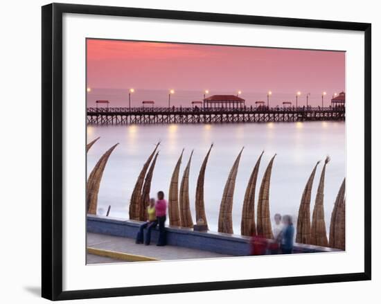 Waterfront Scene at Huanchaco in Peru, Locals Relax Next to Totora Boats Stacked Along the Beach-Andrew Watson-Framed Photographic Print