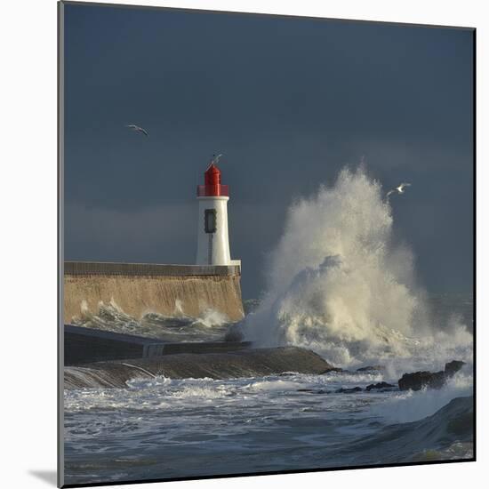 Waves breaking against port wall with lighthouse during storm-Loic Poidevin-Mounted Photographic Print