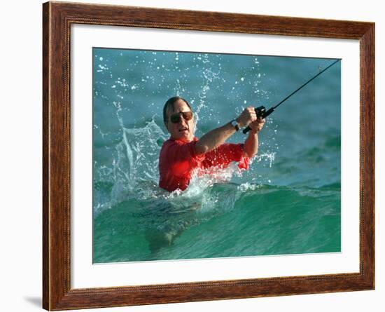 Waves Splash President-Elect George Bush as He Casts a Line While Surf-Fishing-null-Framed Photographic Print