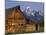 Weathered Wooden Barn Along Mormon Row with the Grand Tetons in Distance, Grand Teton National Park-Dennis Flaherty-Mounted Photographic Print