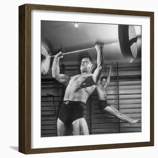 Weightlifter Charlie Morris at Southtown YMCA Working Out While Bob Byerwalter Works on Stall Bar-Ralph Crane-Framed Photographic Print