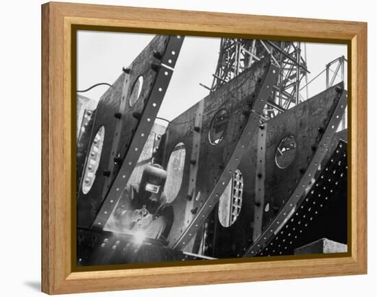 Welder Securing Steel Structure While Working on Hull of a Ship, Bethlehem Shipbuilding Drydock-Margaret Bourke-White-Framed Premier Image Canvas