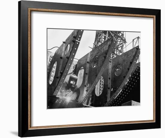 Welder Securing Steel Structure While Working on Hull of a Ship, Bethlehem Shipbuilding Drydock-Margaret Bourke-White-Framed Premium Photographic Print