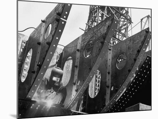 Welder Securing Steel Structure While Working on Hull of a Ship, Bethlehem Shipbuilding Drydock-Margaret Bourke-White-Mounted Premium Photographic Print