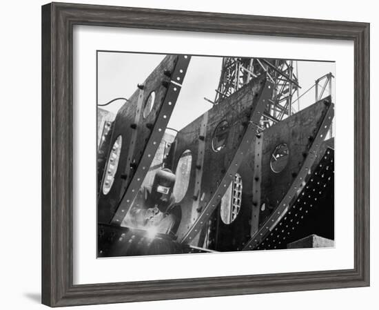 Welder Securing Steel Structure While Working on Hull of a Ship, Bethlehem Shipbuilding Drydock-Margaret Bourke-White-Framed Photographic Print