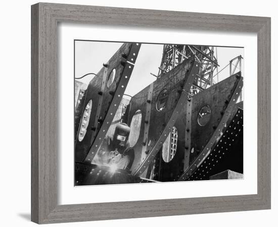 Welder Securing Steel Structure While Working on Hull of a Ship, Bethlehem Shipbuilding Drydock-Margaret Bourke-White-Framed Photographic Print