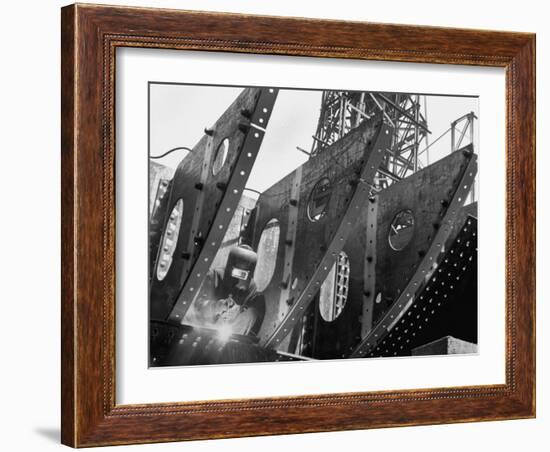 Welder Securing Steel Structure While Working on Hull of a Ship, Bethlehem Shipbuilding Drydock-Margaret Bourke-White-Framed Photographic Print