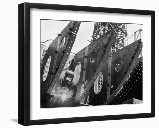 Welder Securing Steel Structure While Working on Hull of a Ship, Bethlehem Shipbuilding Drydock-Margaret Bourke-White-Framed Photographic Print