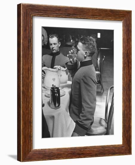 West Point Cadet Drinking a Glass of Water as He Sits at Attention in Mess Hall at the Academy-Alfred Eisenstaedt-Framed Photographic Print