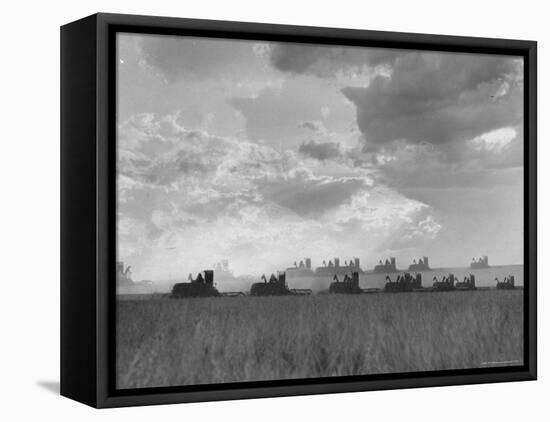 Wheat Harvest Time with Two Lines of Combines Lining Up in Field with Threatening Sky-Joe Scherschel-Framed Premier Image Canvas