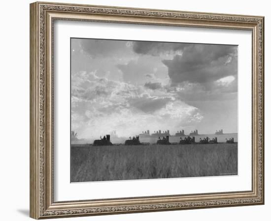 Wheat Harvest Time with Two Lines of Combines Lining Up in Field with Threatening Sky-Joe Scherschel-Framed Photographic Print