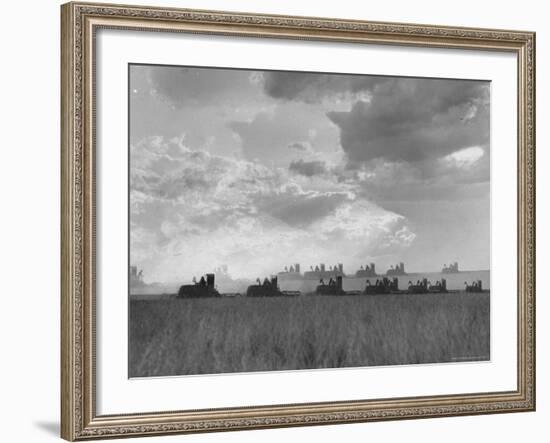 Wheat Harvest Time with Two Lines of Combines Lining Up in Field with Threatening Sky-Joe Scherschel-Framed Photographic Print