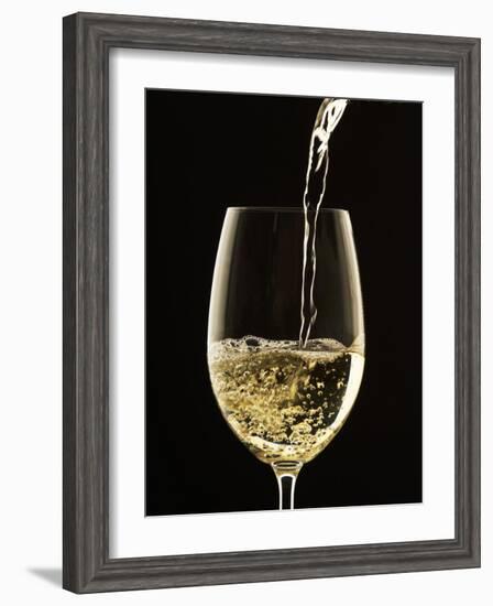 White Wine Pouring from Bottle into Glass-John Hay-Framed Photographic Print