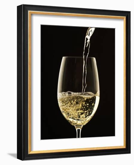 White Wine Pouring from Bottle into Glass-John Hay-Framed Photographic Print