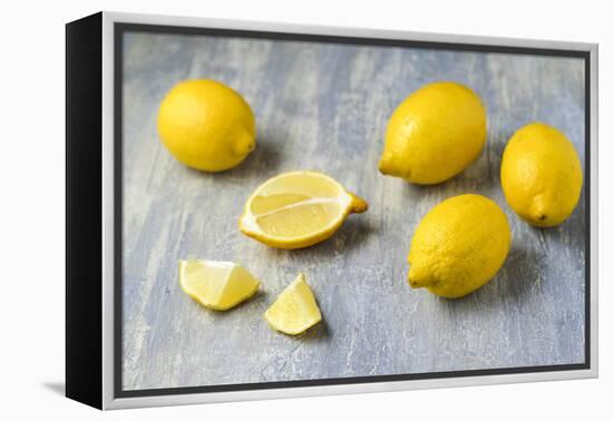 Whole and Sliced Lemons on Grey Subsoil-Jana Ihle-Framed Premier Image Canvas