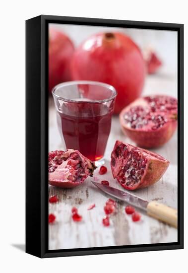 Whole and Sliced Pomegranates, Knives, Glass with Pomegranate Juice-Jana Ihle-Framed Premier Image Canvas