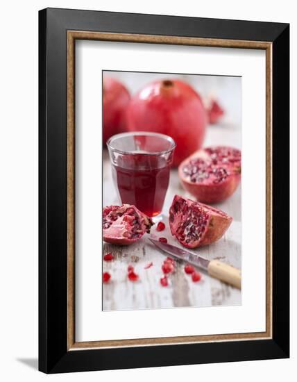 Whole and Sliced Pomegranates, Knives, Glass with Pomegranate Juice-Jana Ihle-Framed Photographic Print