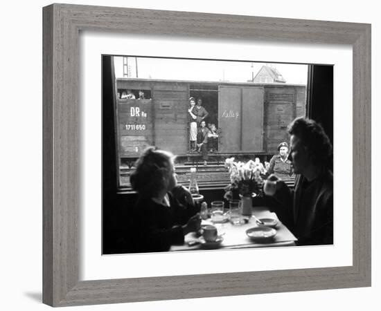 Wife and Daughter of US Soldier in First Class Dining Car Looking at German "Expelles" in Boxcars-Walter Sanders-Framed Photographic Print