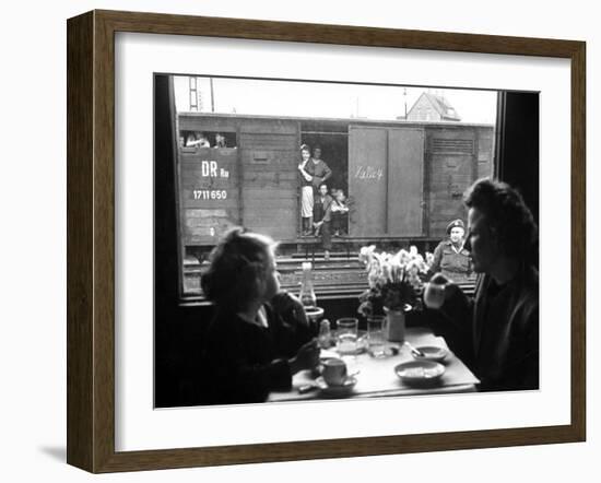 Wife and Daughter of US Soldier in First Class Dining Car Looking at German "Expelles" in Boxcars-Walter Sanders-Framed Photographic Print