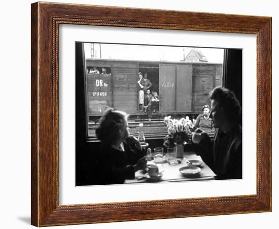 Wife and Daughter of US Soldier in First Class Dining Car Looking at German "Expelles" in Boxcars-Walter Sanders-Framed Photographic Print