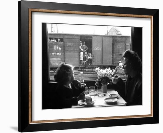 Wife and Daughter of US Soldier in First Class Dining Car Looking at German "Expelles" in Boxcars-Walter Sanders-Framed Photographic Print