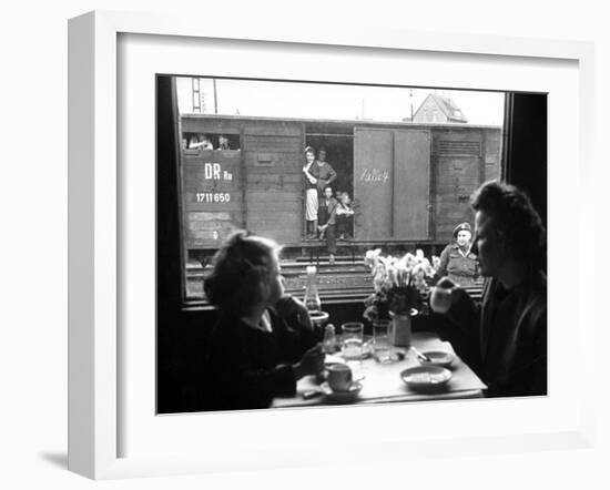 Wife and Daughter of US Soldier in First Class Dining Car Looking at German "Expelles" in Boxcars-Walter Sanders-Framed Photographic Print