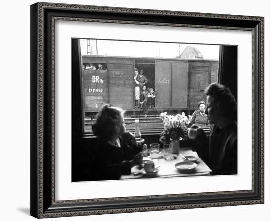 Wife and Daughter of US Soldier in First Class Dining Car Looking at German "Expelles" in Boxcars-Walter Sanders-Framed Photographic Print