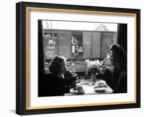 Wife and Daughter of US Soldier in First Class Dining Car Looking at German "Expelles" in Boxcars-Walter Sanders-Framed Photographic Print