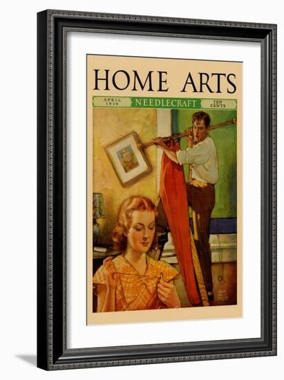 Wife Sews While a Man Hangs a Picture-null-Framed Art Print