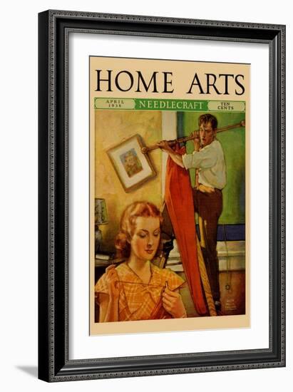 Wife Sews While a Man Hangs a Picture-null-Framed Art Print