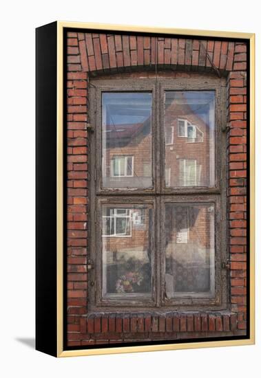 Window in a rowhouse in Wislica, Poland with reflections from the home across the street.-Mallorie Ostrowitz-Framed Premier Image Canvas