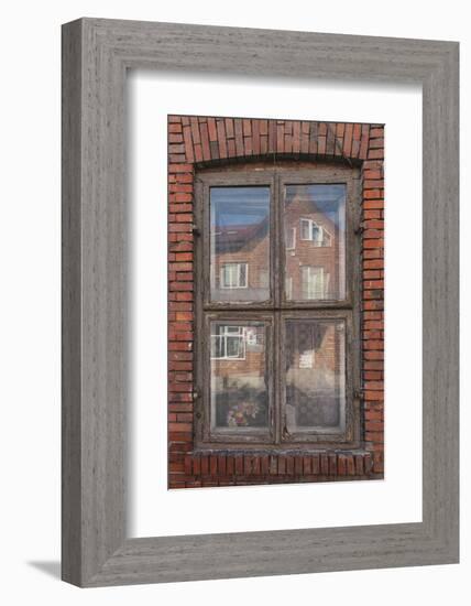 Window in a rowhouse in Wislica, Poland with reflections from the home across the street.-Mallorie Ostrowitz-Framed Photographic Print