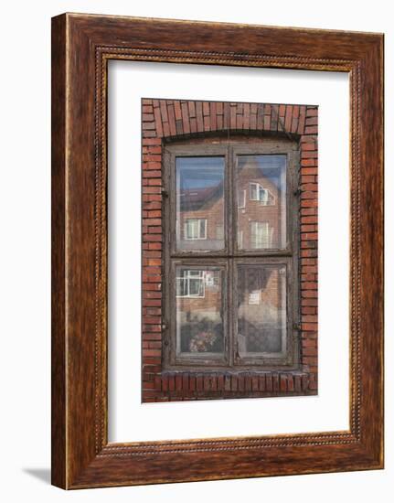 Window in a rowhouse in Wislica, Poland with reflections from the home across the street.-Mallorie Ostrowitz-Framed Photographic Print