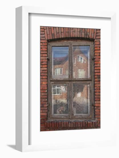 Window in a rowhouse in Wislica, Poland with reflections from the home across the street.-Mallorie Ostrowitz-Framed Photographic Print