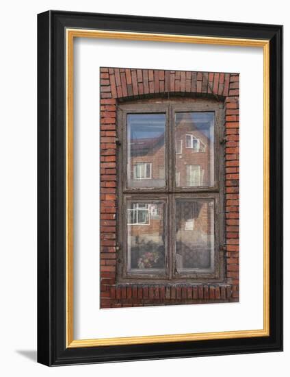 Window in a rowhouse in Wislica, Poland with reflections from the home across the street.-Mallorie Ostrowitz-Framed Photographic Print