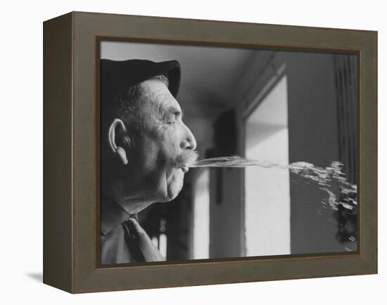 Wine Cellar Master and Taster Spitting Wine-Carlo Bavagnoli-Framed Premier Image Canvas