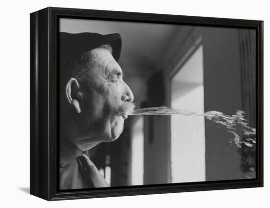 Wine Cellar Master and Taster Spitting Wine-Carlo Bavagnoli-Framed Premier Image Canvas