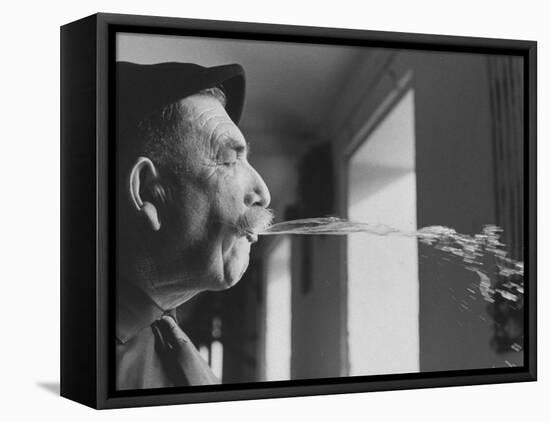 Wine Cellar Master and Taster Spitting Wine-Carlo Bavagnoli-Framed Premier Image Canvas